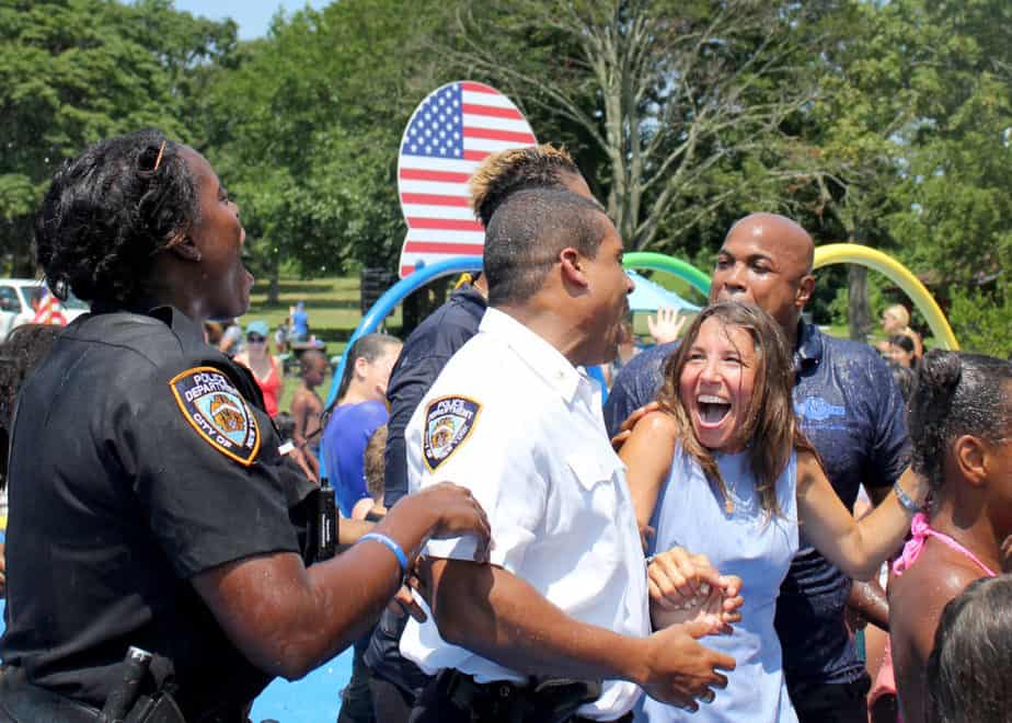 Lisa Tuozzolo and members of the NYPD after getting soaked/Photo by Molly Prep