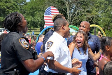 Lisa Tuozzolo and members of the NYPD after getting soaked/Photo by Molly Prep