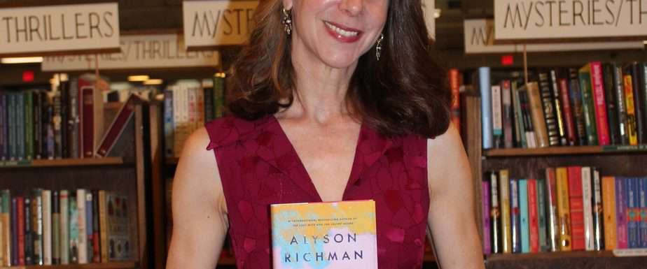 Alyson Richman with a copy of her new book The Secret of Clouds