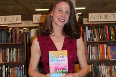 Alyson Richman with a copy of her new book The Secret of Clouds
